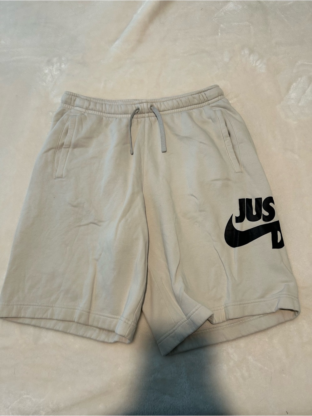 Nike Men’s Cream Athletic Shorts with Black Swoosh Graphic
